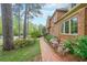 Brick walkway leading to a beautiful home with manicured landscaping and mature trees, creating a serene setting at 3358 Stovehill Se Ct, Marietta, GA 30067