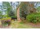 Beautiful brick home exterior with lush landscaping, mature trees, and a private driveway for curb appeal at 3358 Stovehill Se Ct, Marietta, GA 30067