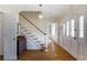 Elegant foyer with hardwood floors, staircase, and decorative front door with sidelights at 3358 Stovehill Se Ct, Marietta, GA 30067