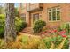 Beautifully landscaped front yard with colorful flowers, brick pathway, and a grand entrance at 3358 Stovehill Se Ct, Marietta, GA 30067