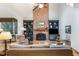 Bright living room with a brick fireplace, dark green built-ins, and hardwood floors at 3358 Stovehill Se Ct, Marietta, GA 30067