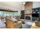 Inviting living room with a brick fireplace, large windows, and beautiful hardwood floors at 3358 Stovehill Se Ct, Marietta, GA 30067