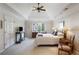 Spacious main bedroom with a tray ceiling, plush carpet, and a bright window at 3358 Stovehill Se Ct, Marietta, GA 30067