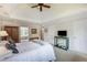 Well-lit main bedroom featuring a tray ceiling, plush carpet, and a view of the outdoors at 3358 Stovehill Se Ct, Marietta, GA 30067