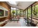 Cozy sunroom with brick accents, screened windows, and comfortable seating for relaxing and enjoying the view at 3358 Stovehill Se Ct, Marietta, GA 30067
