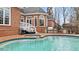 Beautiful backyard pool and patio, including a built-in outdoor kitchen and stainless steel BBQ at 5560 Stoneleigh Dr, Suwanee, GA 30024