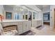 Bathroom with a vanity and double sinks under a large mirror, with tile flooring and natural light at 5560 Stoneleigh Dr, Suwanee, GA 30024