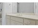 Bathroom featuring white cabinetry, a pristine countertop, and a large, frameless mirror at 5560 Stoneleigh Dr, Suwanee, GA 30024