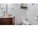 Stylish powder room with unique wallpaper, modern sink, and dark wood vanity at 5560 Stoneleigh Dr, Suwanee, GA 30024