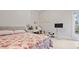 Bedroom with floral bedding, stylish furniture, TV and fun decorative touches at 5560 Stoneleigh Dr, Suwanee, GA 30024