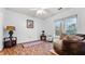 A naturally-lit bedroom featuring hardwood floors, a ceiling fan, and a large window at 5560 Stoneleigh Dr, Suwanee, GA 30024