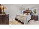 Bedroom with hardwood furniture, plush comforter, a fur rug and bright natural light at 5560 Stoneleigh Dr, Suwanee, GA 30024