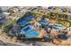 A high angle showing a community pool and tennis courts with surrounding trees at 5560 Stoneleigh Dr, Suwanee, GA 30024