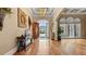 Inviting foyer with hardwood floors, elegant lighting, and arched windows at 5560 Stoneleigh Dr, Suwanee, GA 30024
