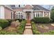 Charming brick walkway leads to the front door with lush landscaping at 5560 Stoneleigh Dr, Suwanee, GA 30024