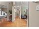 Inviting hallway with hardwood floors and views into adjoining rooms at 5560 Stoneleigh Dr, Suwanee, GA 30024