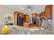 Open kitchen with granite countertops, stainless steel appliances, and wooden cabinets at 5560 Stoneleigh Dr, Suwanee, GA 30024