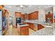 Well-lit kitchen featuring wooden cabinets, granite countertops, stainless steel appliances at 5560 Stoneleigh Dr, Suwanee, GA 30024