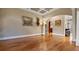 Open-concept living space with hardwood floors and arched doorways at 5560 Stoneleigh Dr, Suwanee, GA 30024