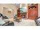 Comfortable living room with a fireplace and large built-in entertainment center for storage at 5560 Stoneleigh Dr, Suwanee, GA 30024