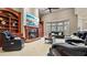 Bright living room featuring a fireplace, built-in shelving, and comfortable leather seating at 5560 Stoneleigh Dr, Suwanee, GA 30024