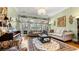 Elegant living room with grand piano, large windows and comfortable seating at 5560 Stoneleigh Dr, Suwanee, GA 30024