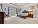 Expansive main bedroom with a large window, decorative ceilings, and a cozy sitting area at 5560 Stoneleigh Dr, Suwanee, GA 30024