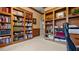 Spacious home office with custom built-ins, filled with books and office equipment at 5560 Stoneleigh Dr, Suwanee, GA 30024