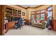 Spacious home office with custom built-ins, comfortable seating, and bright natural light at 5560 Stoneleigh Dr, Suwanee, GA 30024