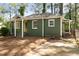 Green home with a light-colored roof, complemented by lush greenery, shows off its curb appeal at 720 Maynard Se Ter, Atlanta, GA 30316