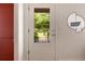Modern white front door with a glass insert, offering a view of the green and vibrant outdoors at 720 Maynard Se Ter, Atlanta, GA 30316