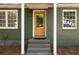Close-up of a welcoming front entrance with an eye-catching yellow door and white window frames at 720 Maynard Se Ter, Atlanta, GA 30316