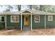 Charming home exterior with green paint, covered front porch, and well-maintained landscaping at 720 Maynard Se Ter, Atlanta, GA 30316