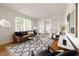 Bright living room with hardwood floors, modern furniture, stylish rug and bright natural light at 720 Maynard Se Ter, Atlanta, GA 30316
