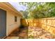 Fenced backyard with newly built wood fence and side door access at 1755 Rockbridge Nw Rd, Conyers, GA 30012
