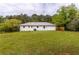 Spacious backyard with lush green grass and mature trees, perfect for outdoor activities at 1755 Rockbridge Nw Rd, Conyers, GA 30012
