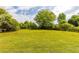 Large, green backyard with ample space and a metal carport, ideal for outdoor living and entertainment at 1755 Rockbridge Nw Rd, Conyers, GA 30012