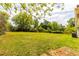 Lush backyard with mature trees, a metal carport, and ample green space, offering privacy and tranquility at 1755 Rockbridge Nw Rd, Conyers, GA 30012