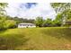 Expansive backyard featuring a well-maintained lawn and ample space for gardening or recreation at 1755 Rockbridge Nw Rd, Conyers, GA 30012