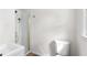Well-lit bathroom showcasing a shower with gold trim and modern toilet at 1755 Rockbridge Nw Rd, Conyers, GA 30012