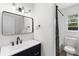 Stylish bathroom featuring modern vanity, mirror, and shower-tub combination at 1755 Rockbridge Nw Rd, Conyers, GA 30012