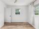 Bright bedroom with natural light, wood-look floors, and a neutral color palette at 1755 Rockbridge Nw Rd, Conyers, GA 30012