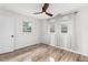Light-filled bedroom with wood-look floors, large windows, and closet at 1755 Rockbridge Nw Rd, Conyers, GA 30012