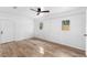 Spacious bedroom with wood-look floors, neutral paint, and ample natural light at 1755 Rockbridge Nw Rd, Conyers, GA 30012
