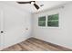 Charming bedroom featuring wood-look floors, ceiling fan, and a bright, airy feel at 1755 Rockbridge Nw Rd, Conyers, GA 30012