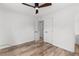 Cozy bedroom featuring wood-look floors and a ceiling fan for added comfort at 1755 Rockbridge Nw Rd, Conyers, GA 30012