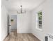 Bright dining room with wood floors and a view into another living area at 1755 Rockbridge Nw Rd, Conyers, GA 30012