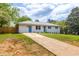Beautiful single-story home with a long driveway, white exterior and well-maintained lawn at 1755 Rockbridge Nw Rd, Conyers, GA 30012