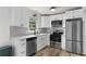 Modern kitchen with white cabinets, stainless steel appliances, and stylish backsplash at 1755 Rockbridge Nw Rd, Conyers, GA 30012