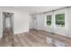 Airy living room with light-colored hardwood flooring, large windows and white trim at 1755 Rockbridge Nw Rd, Conyers, GA 30012